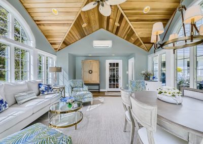 A glorious sunroom with custom wood ceiling and chandelier and multiple windows allowing natural lighting for do I need a general contractor to renovate blog.
