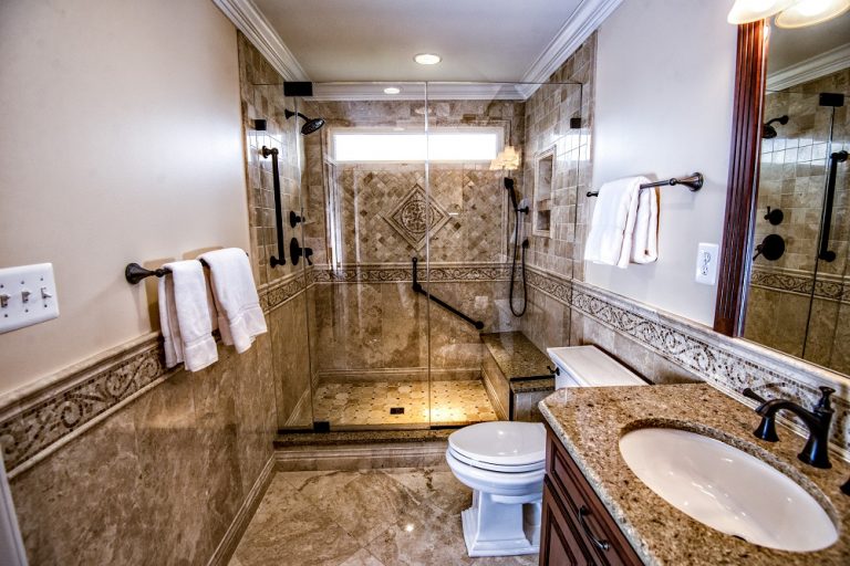Remodeled bathroom with brown marbled tile by Cossentino & Sons for Custom Remodeling in Carroll County, MD